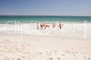 Senior friends holding surfboard