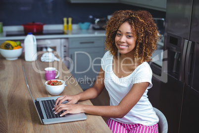 Portrait of young woman using laptop at table Portrait of young woman using laptop at table