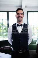 Portrait of waiter smiling at camera