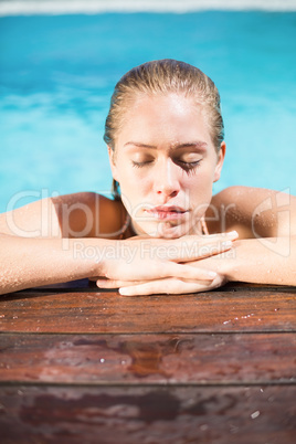 Beautiful woman leaning on poolside