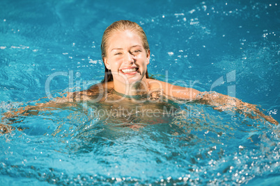 Portrait of beautiful woman swimming in swimming pool