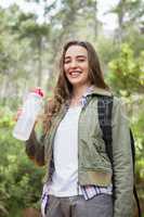Woman drinking water with backpack