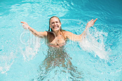 Beautiful woman enjoying in swimming pool