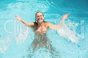 Beautiful woman enjoying in swimming pool