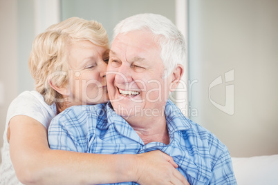 Senior woman kissing husband