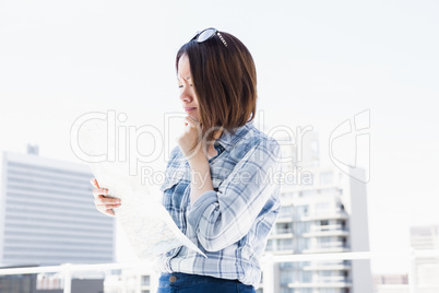 Young woman looking at map for direction
