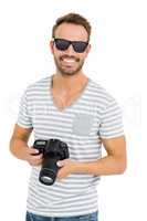 Young man holding digital camera