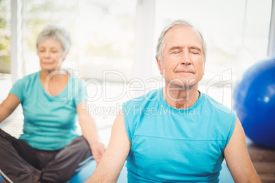 Couple meditating at home