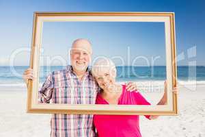 Senior couple holding frame