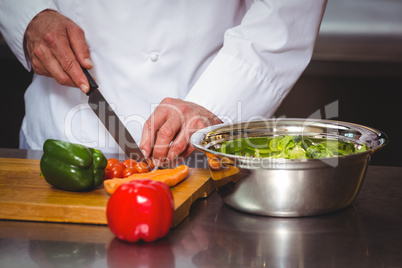 Chef cutting vegetables for a salad