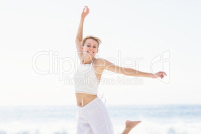 Carefree woman in jumping on the beach