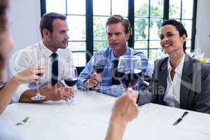 Group of businesspeople drinking wine glass during business lunc