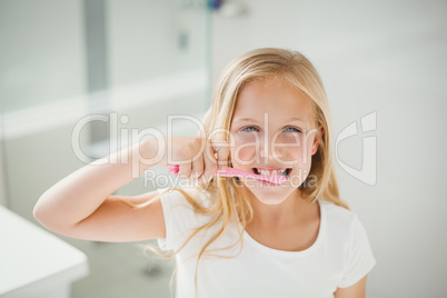 Portrait of girl brushing teeth