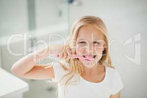 Portrait of girl brushing teeth