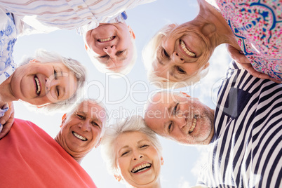 Senior friends standing in circle