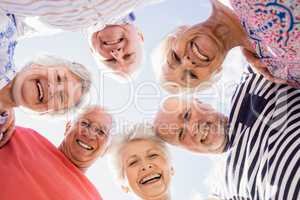 Senior friends standing in circle