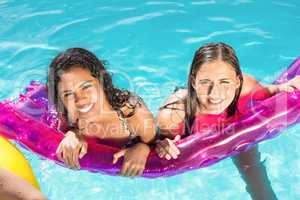 Happy friends enjoying in the swimming pool