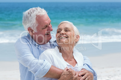 Senior couple embracing with arms around