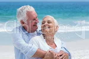 Senior couple embracing with arms around