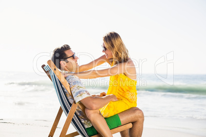 Woman sitting on mans lap at beach