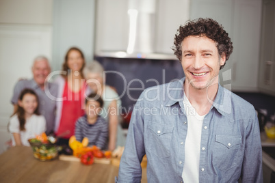 Portrait of young man with family in kitchen