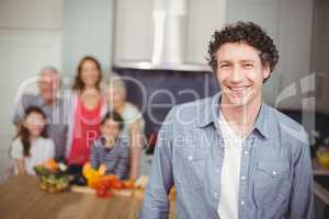 Portrait of young man with family in kitchen