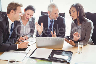 Businesspeople interacting in conference room