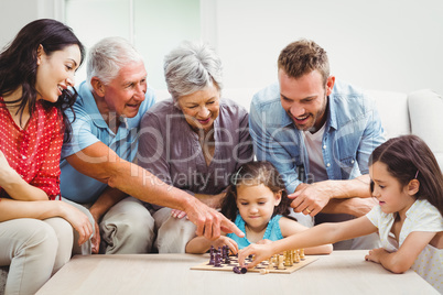 Smiling family playing chess