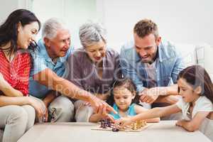 Smiling family playing chess