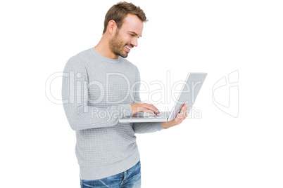 Happy young man using laptop