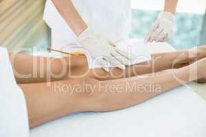 Woman receiving hot wax treatment