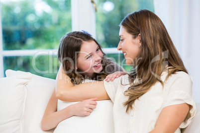 Young woman with daughter on sofa