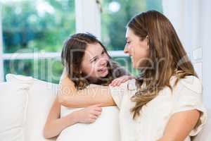 Young woman with daughter on sofa