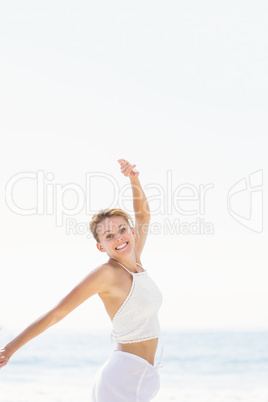 Portrait of beautiful woman stretching her arms on the beach