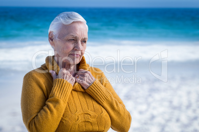 Thoughtful senior woman at the beach