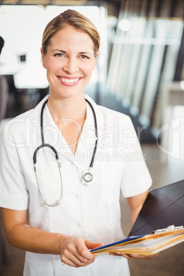 Portrait of female doctor holding medical report