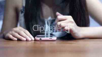 Soft focused young girl browsing smartphone