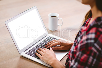 Midsection of woman typing on laptop