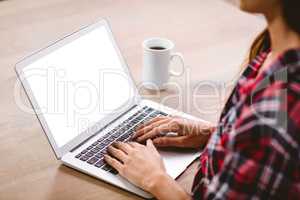Midsection of woman typing on laptop