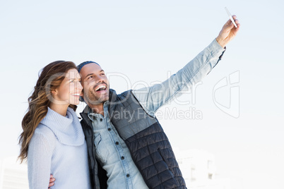 Happy young couple taking selfie