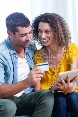 Couple doing online shopping on digital tablet