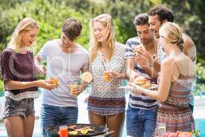 Group of friends having hamburgers and juice