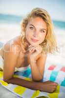 Woman lying on a towel at the beach