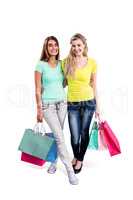 Portrait of cheerful female friends holding shopping bags