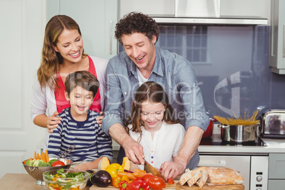 Happy family standing in kitchen