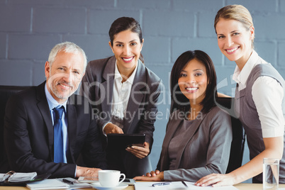 Businesspeople smiling in conference room