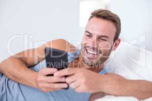 Young man lying on bed