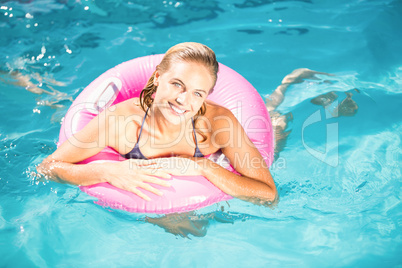 Beautiful young woman enjoying in the swimming pool