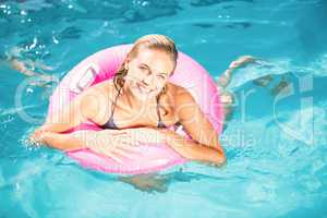 Beautiful young woman enjoying in the swimming pool