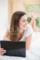 Smiling woman holding digital tablet